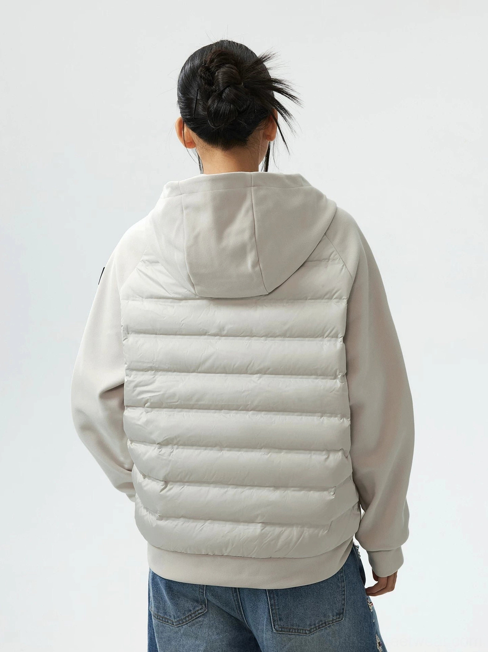 Light gray hybrid hooded goose down jacket back view showing quilted back panel raglan sleeves and hood
