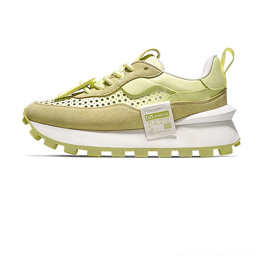 Side view of lime green and olive color-blocked retro running sneakers with chunky matching outsole and layered streetwear silhouette