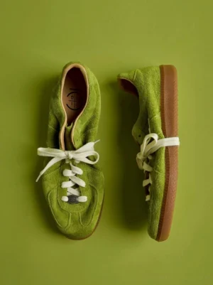 Lime green vintage suede heritage sneakers with off-white laces and gum rubber sole in top-down flat lay view