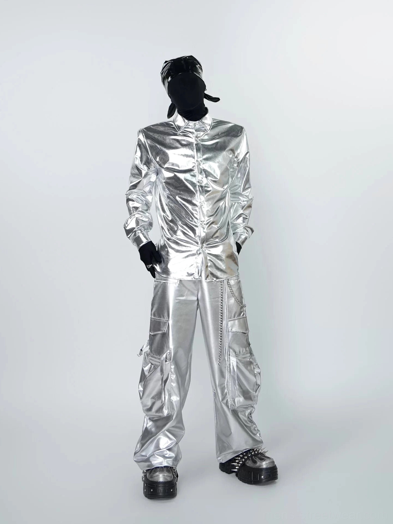 Full front outfit view featuring a glossy silver liquid metal shirt, metallic cargo pants, platform shoes, and chain details for avant-garde streetwear