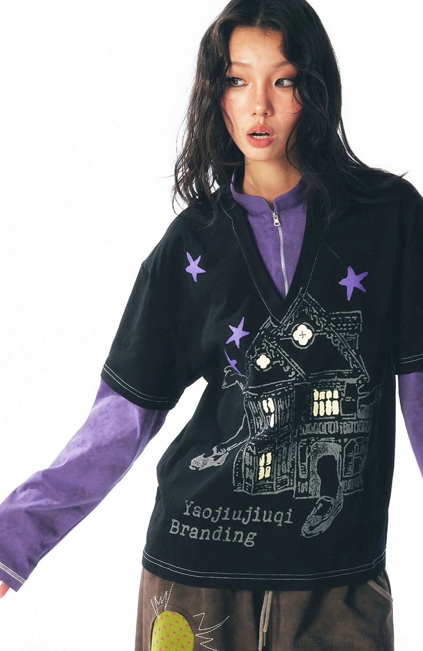 Female model in a loose fit black and purple layered long sleeve streetwear shirt with full front retro graphic