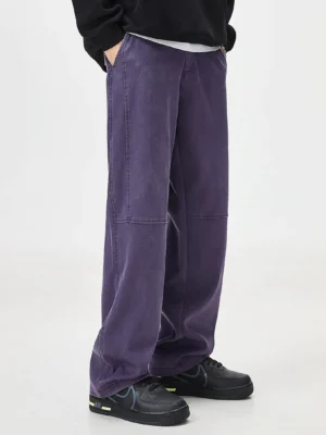 Left side view of loose straight-leg washed pants showing the relaxed silhouette, smooth drape, and concealed side waist pocket design