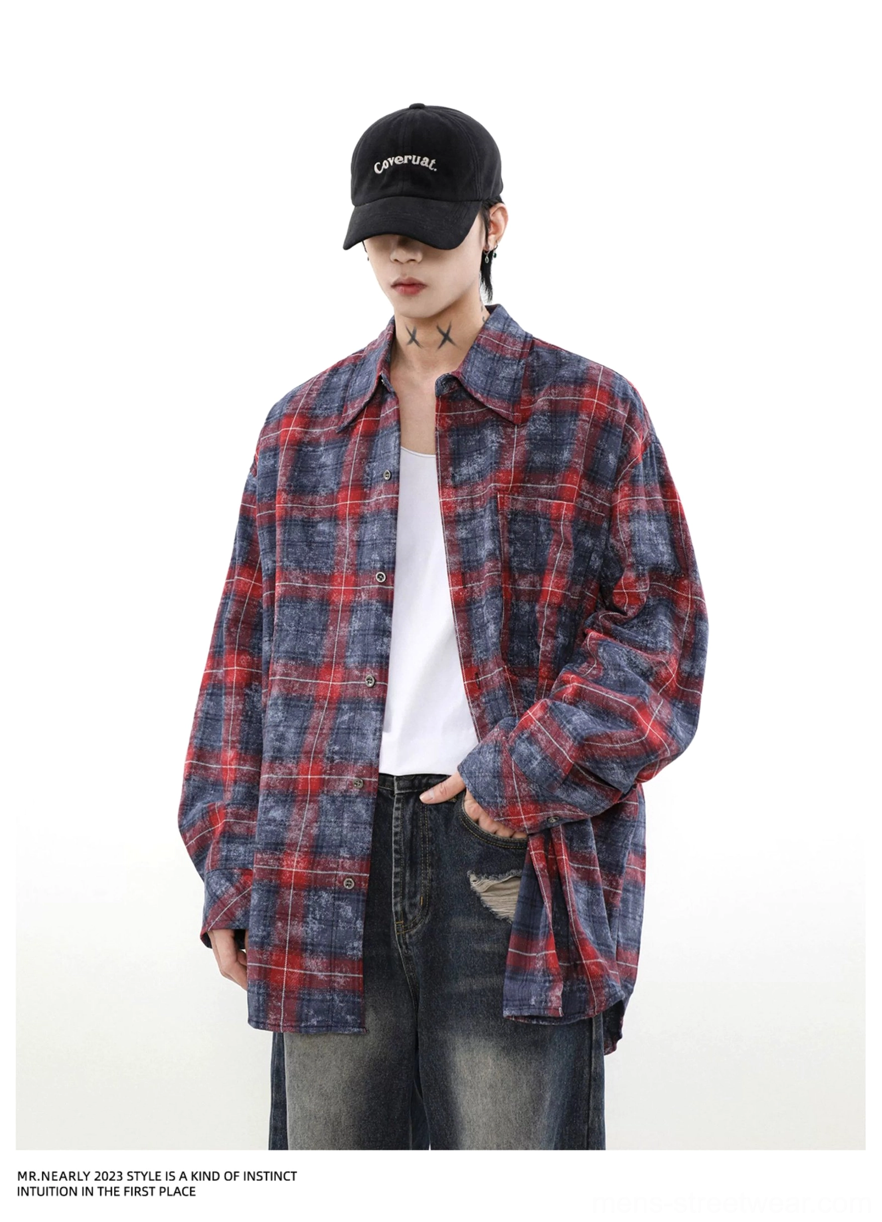Front detail view of a loose washed plaid overshirt with vintage distressed finish, white inner layer, and ripped jeans