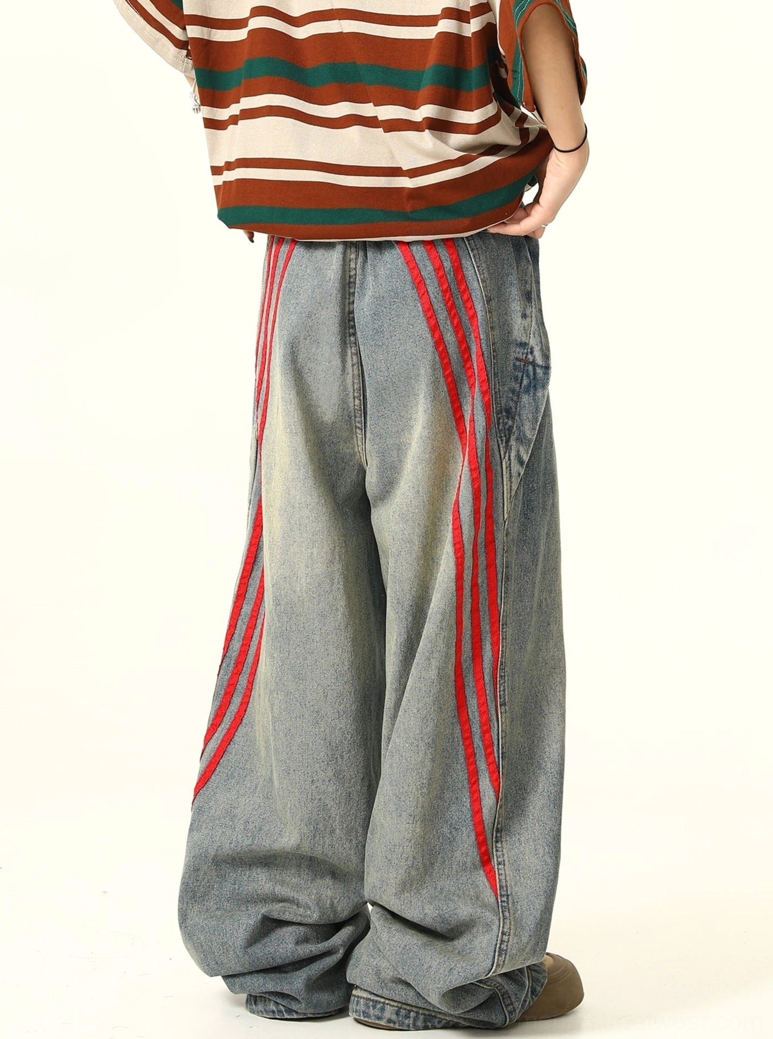 Full back view of loose wide-leg vintage blue denim jeans with symmetrical red triple-stripe trims on the outer legs