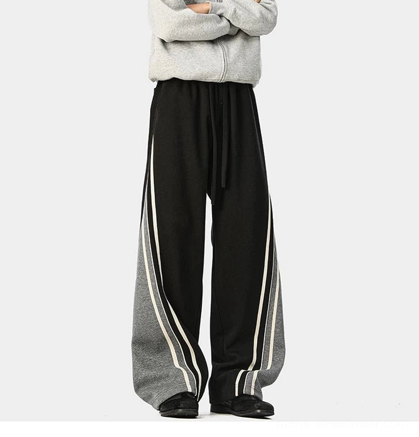 Loose wide-leg streetwear track pants designed with retro varsity details and a comfortable elastic waistband