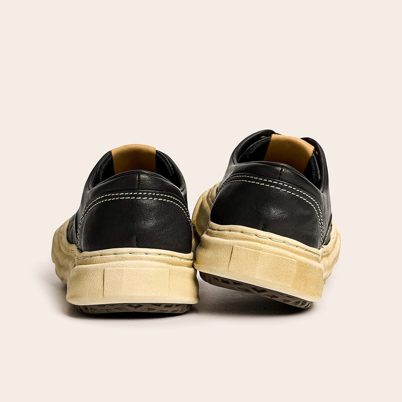 Low-top distressed cowhide leather sneakers with washed finish, rugged vintage character, cushioned rubber foam sole, and classic lace closure