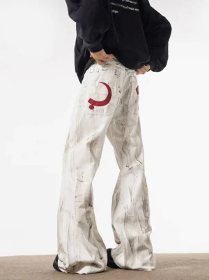 Back three-quarter view of white Lunar Brushstroke wide-leg jeans with grey painterly denim marks, red crescent back pocket graphic, oversized puddle hem, and black streetwear hoodie styling