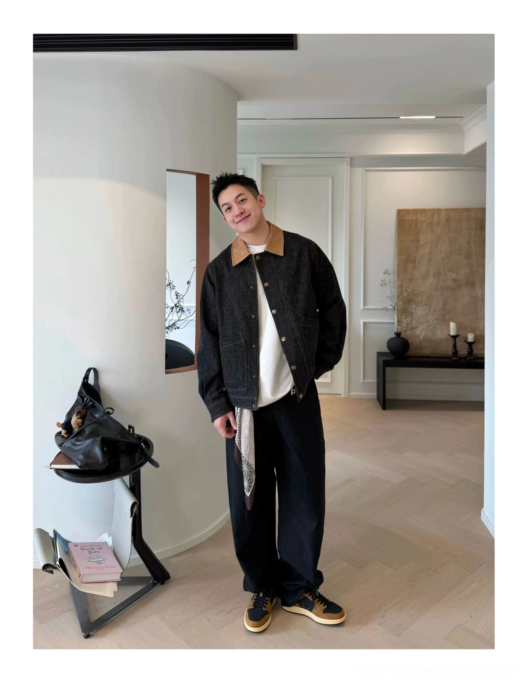 Male model wearing vintage color-block leather court sneakers with casual streetwear outfit in a modern home entryway