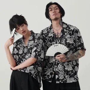 Matching unisex black and white floral Hawaiian couple shirts with relaxed Korean streetwear styling