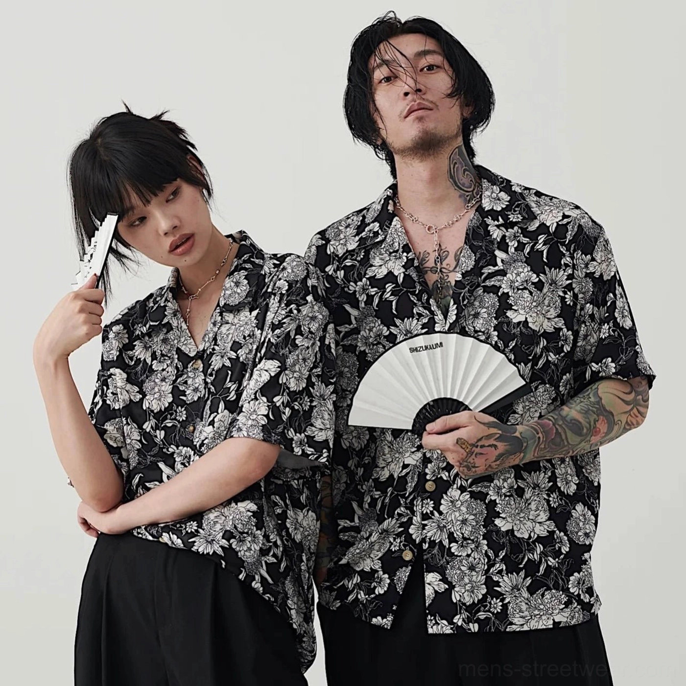 Matching unisex black and white floral Hawaiian couple shirts with relaxed Korean streetwear styling