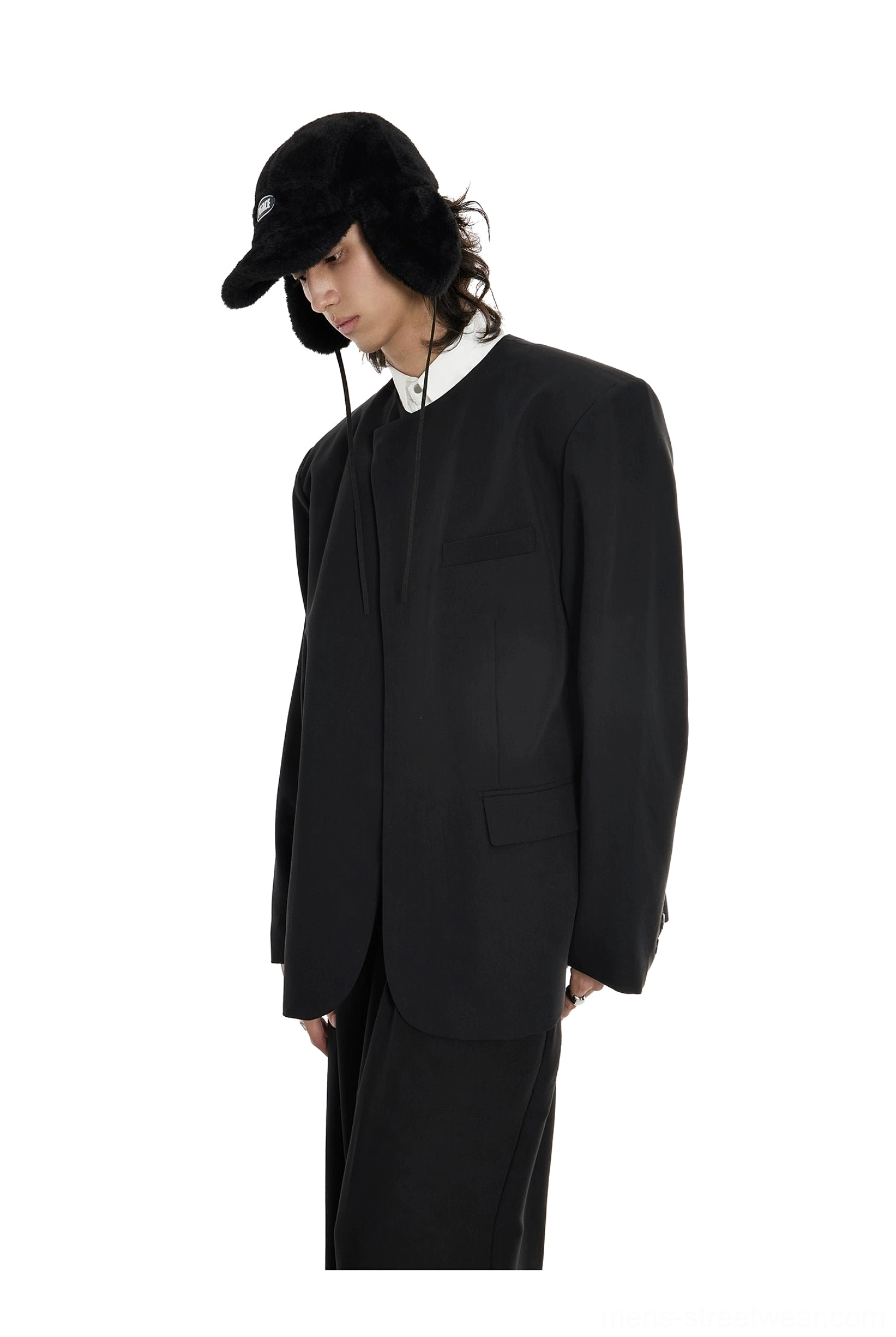 Three-quarter side view of matte black lapel-free blazer in contemporary Seoul fashion styling