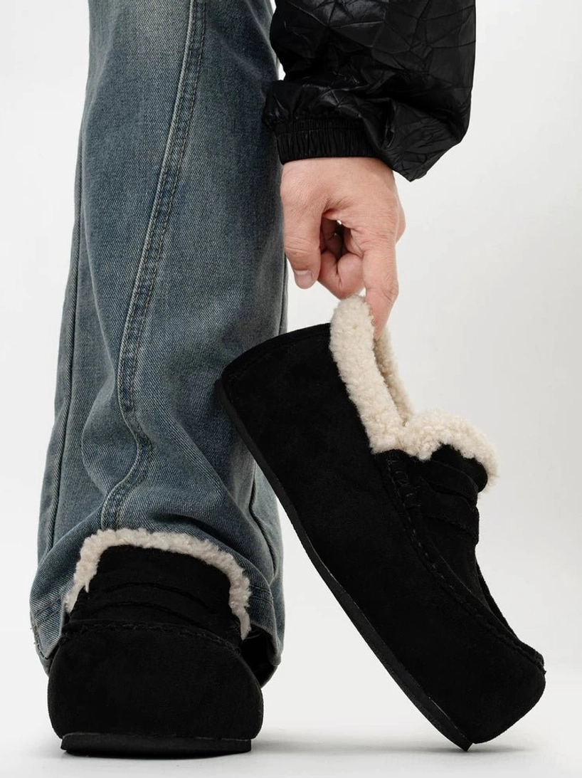 Matte black shearling lined suede slip-on loafers with chunky sole shown in side profile