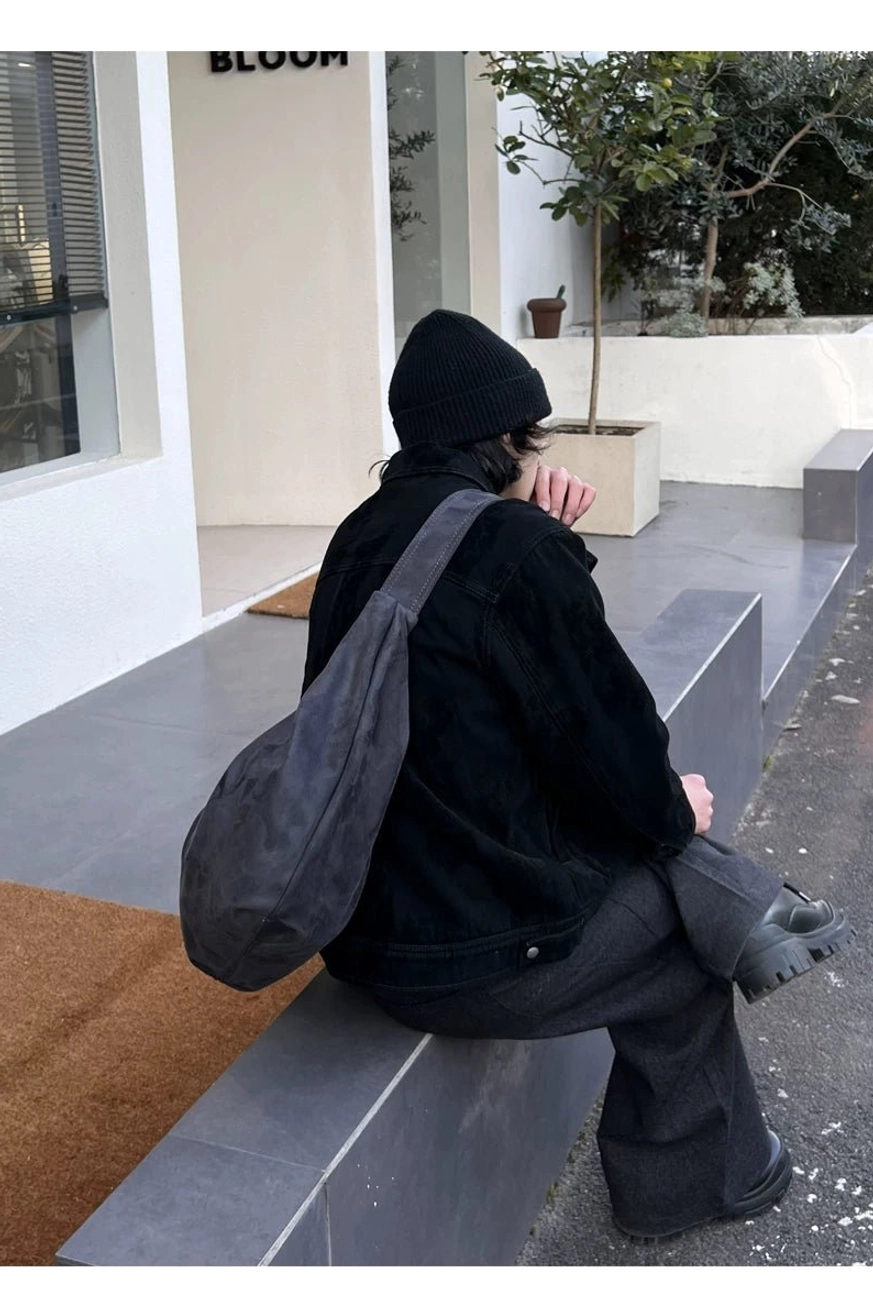 Matte gray crescent hobo shoulder bag in relaxed side back view with soft draped streetwear styling