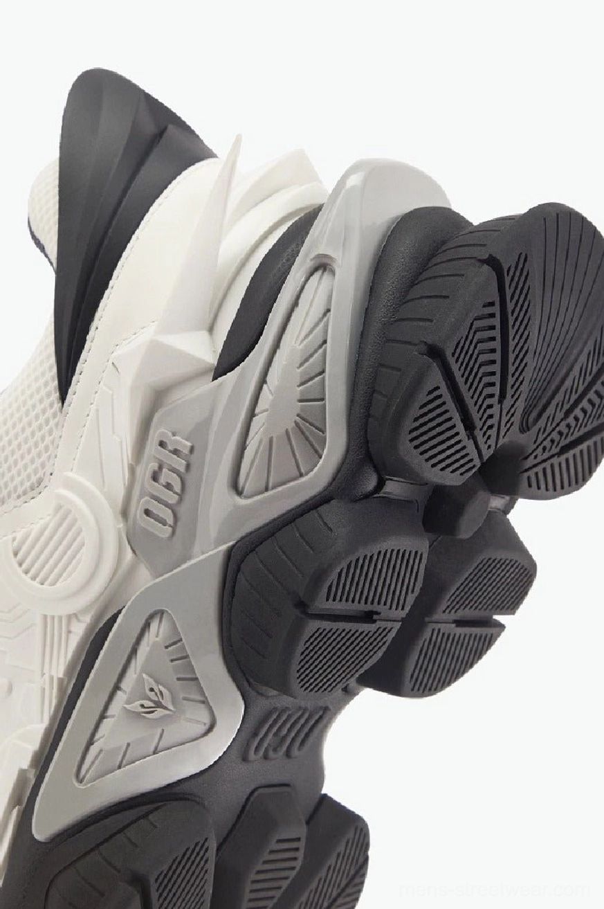 Detailed outsole view of chunky mecha platform sneakers showing segmented mechanical structure and textured rubber tread pattern