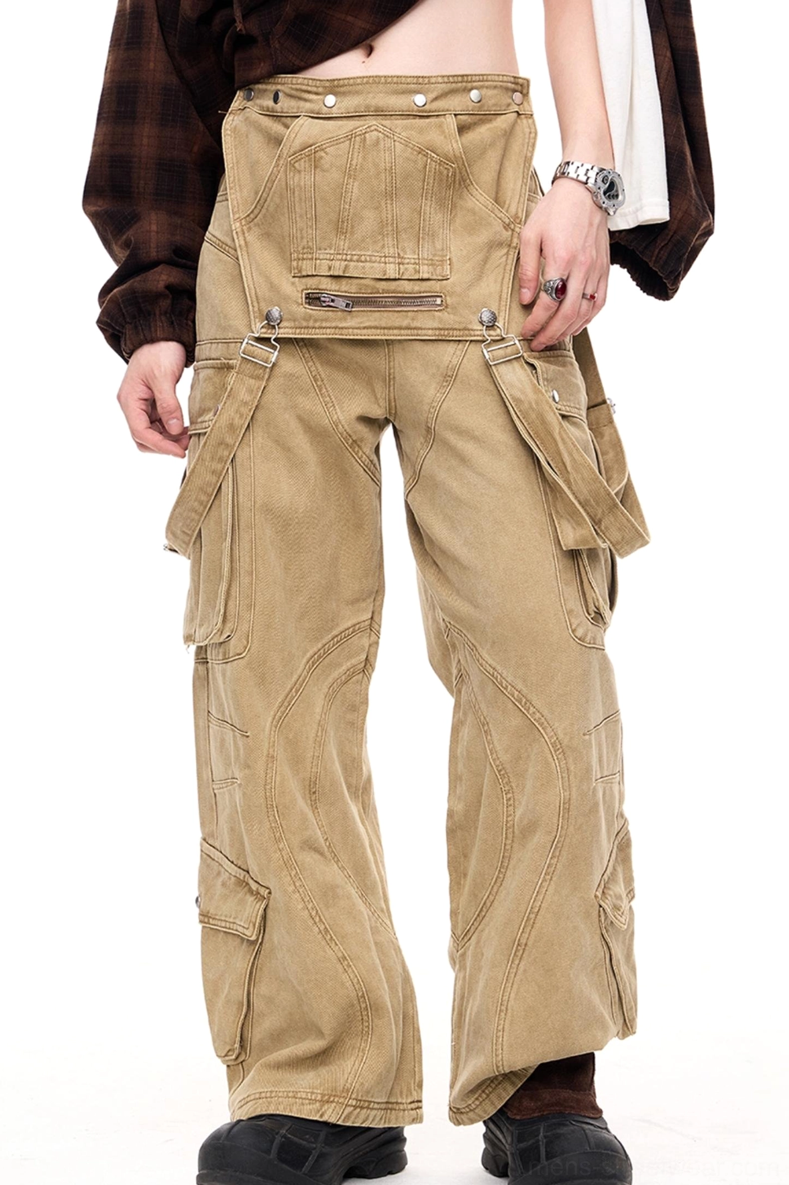Men's apricot khaki detachable cargo pants shown from the front three-quarter view with a removable zipper pocket panel, wide-leg streetwear fit, and black leather boots