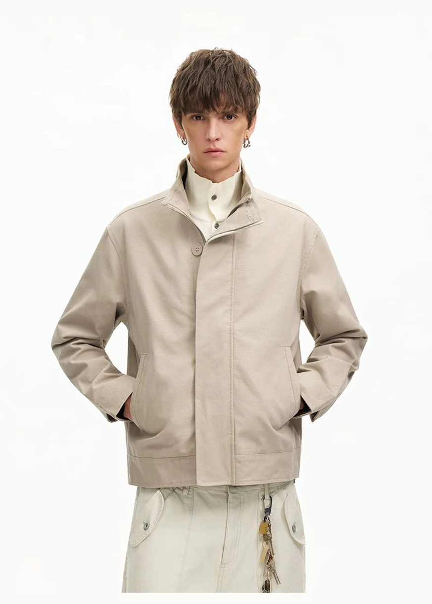 Men's apricot minimal Harrington jacket showing natural fabric texture relaxed fit and stand collar