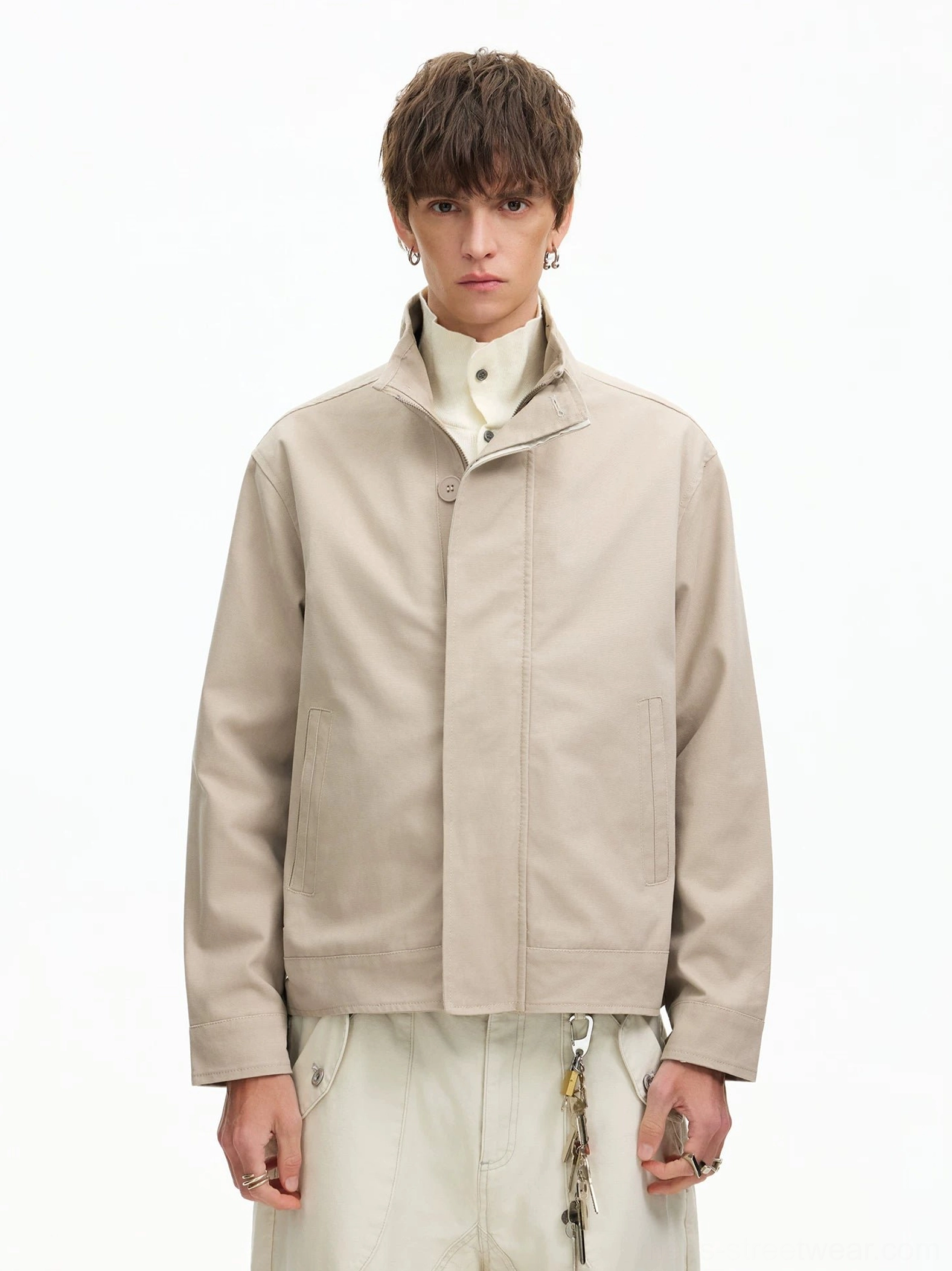 Men's apricot minimal stand collar Harrington jacket front view styled with turtleneck and cream cargo pants