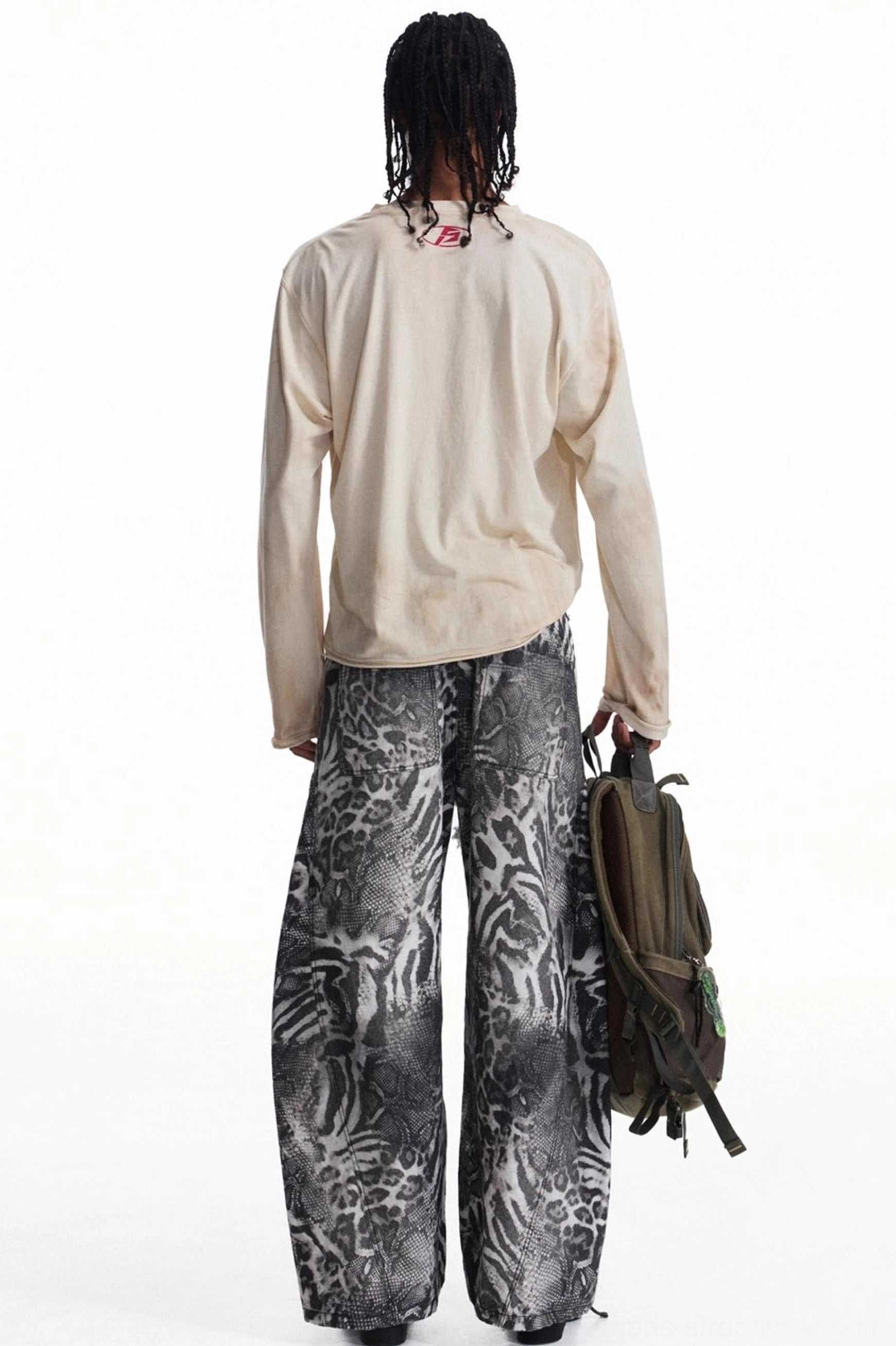 Back outfit view of men's apricot relaxed long sleeve vintage t-shirt with olive backpack and subtle neckline detail
