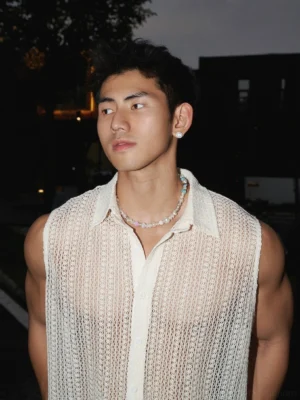Men's apricot sleeveless open-knit crochet shirt close-up showing sheer hollow weave point collar and button front
