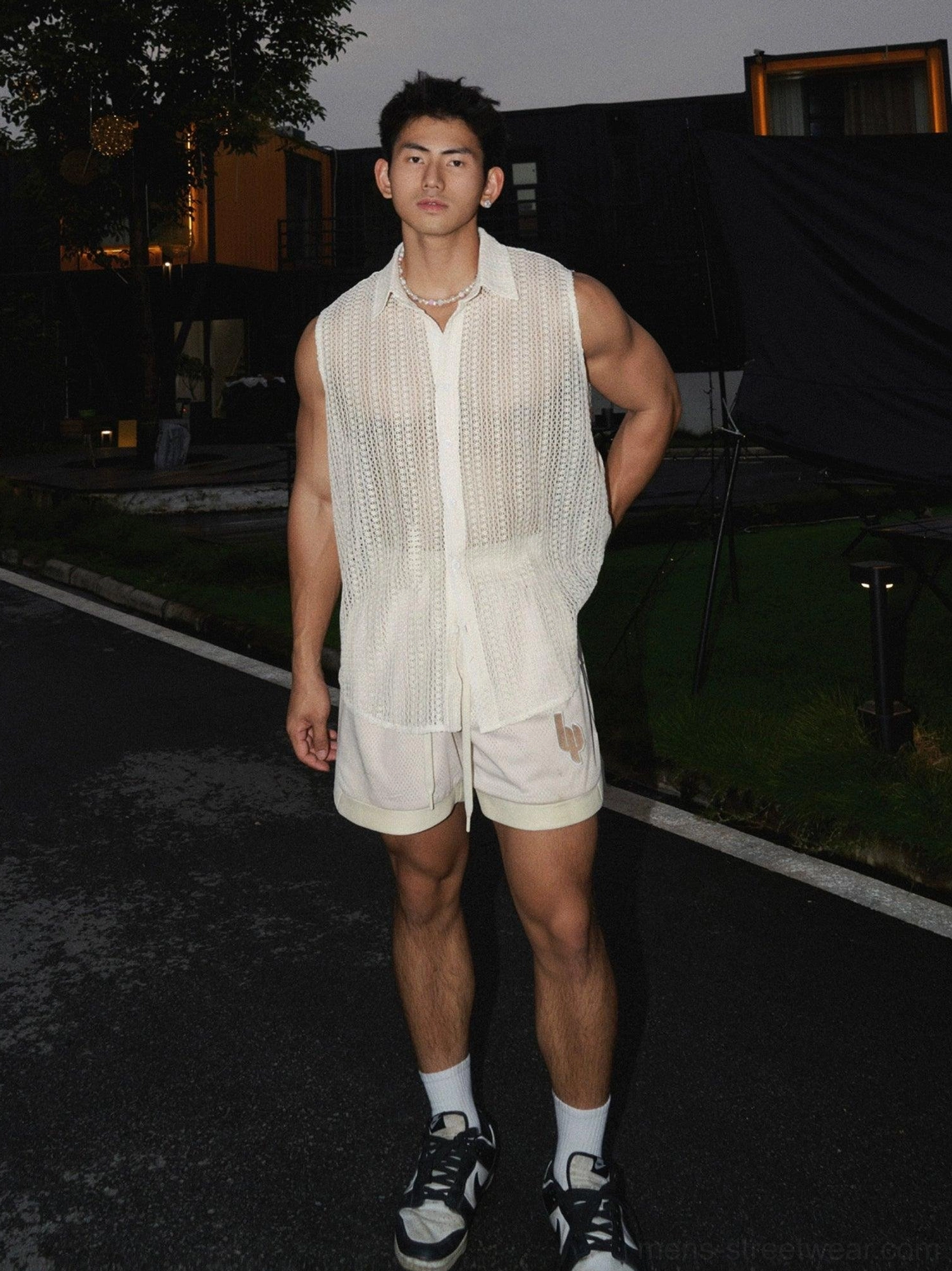 Men's apricot sleeveless crochet shirt full front view with open-knit texture beige shorts and sneakers