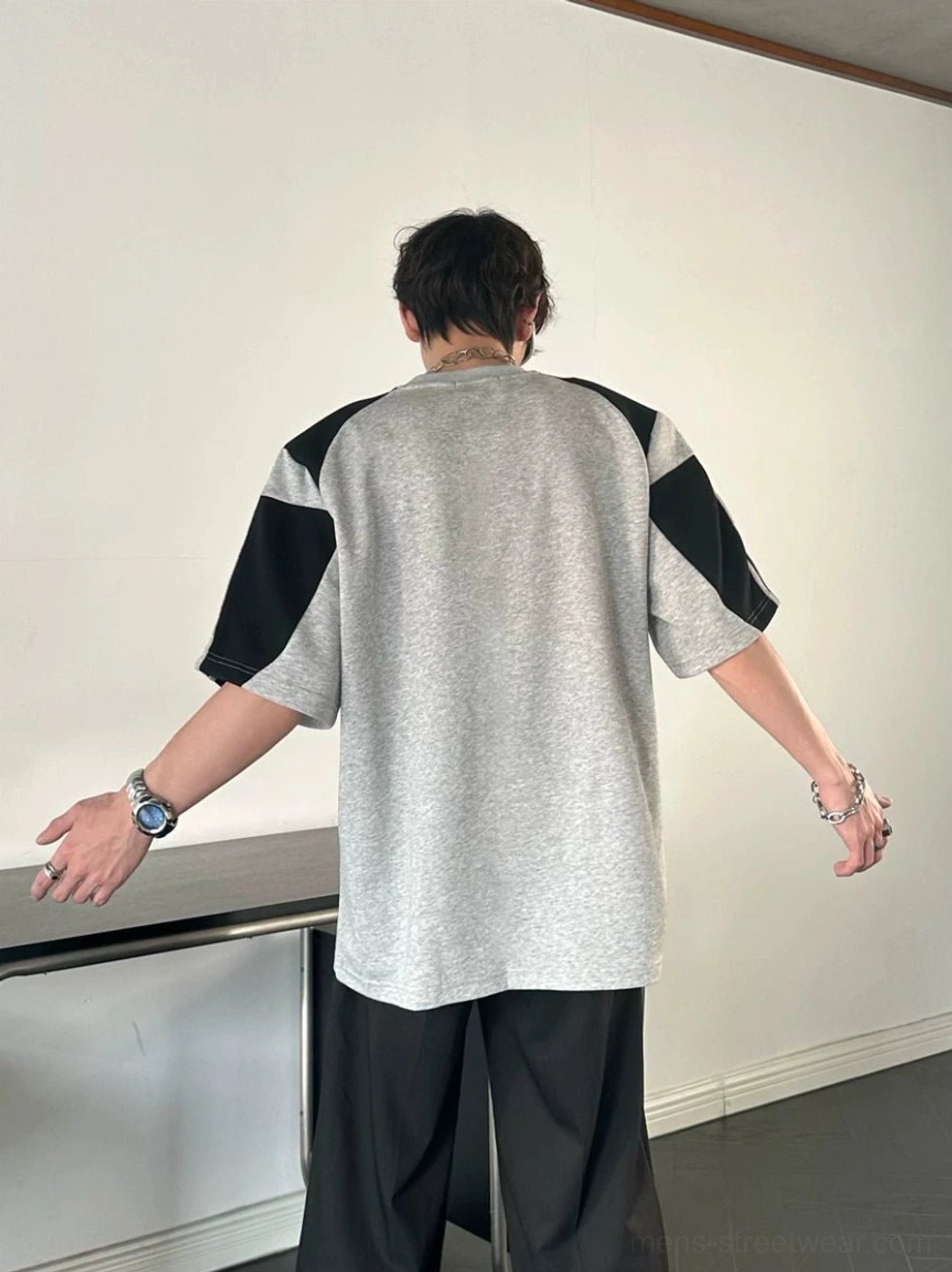Athletic colorblock tee for men featuring contrast sleeves and contemporary varsity streetwear styling