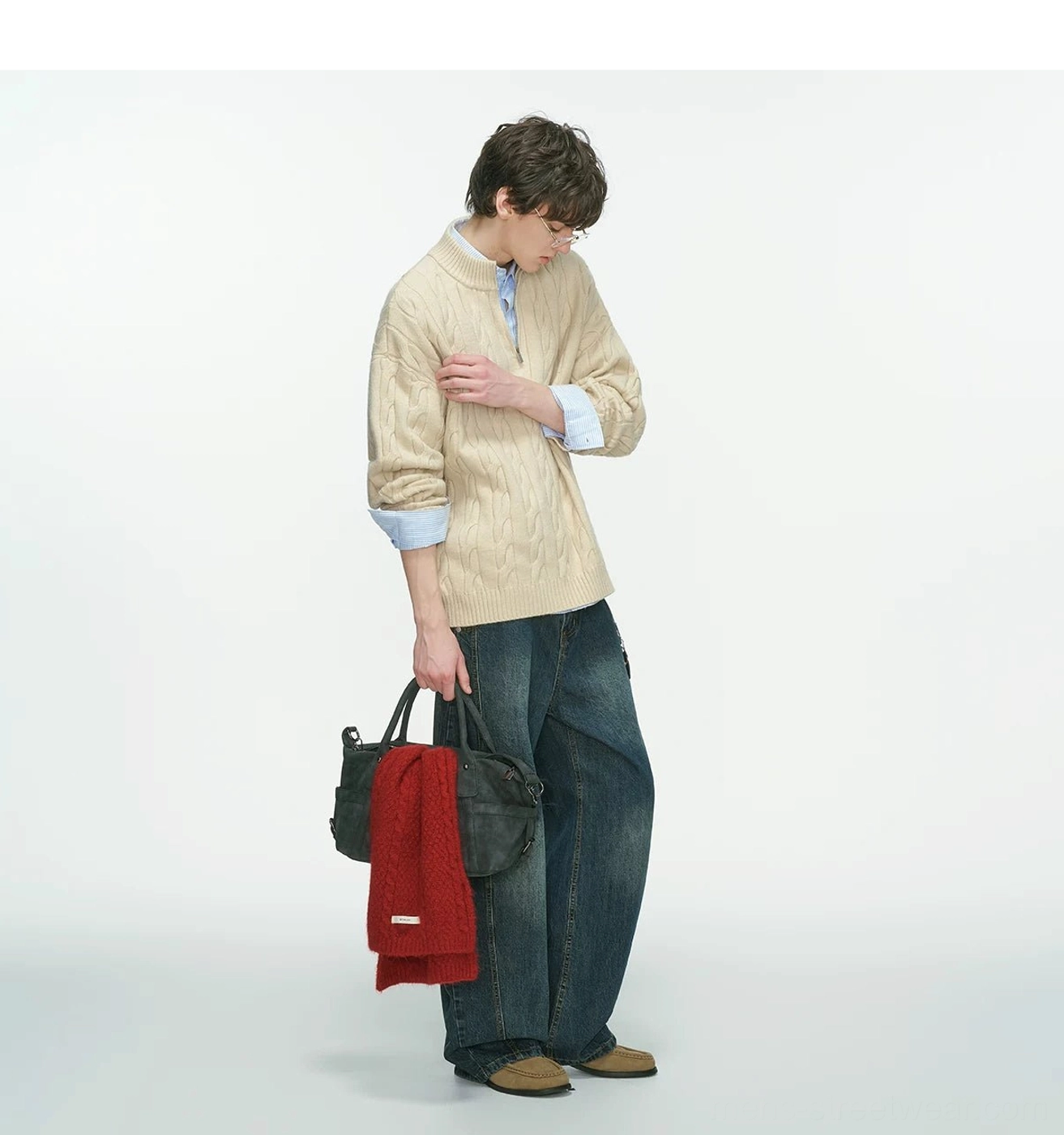 Back side view of a beige cable knit half-zip sweater for men with a stand collar and layered shirt cuffs
