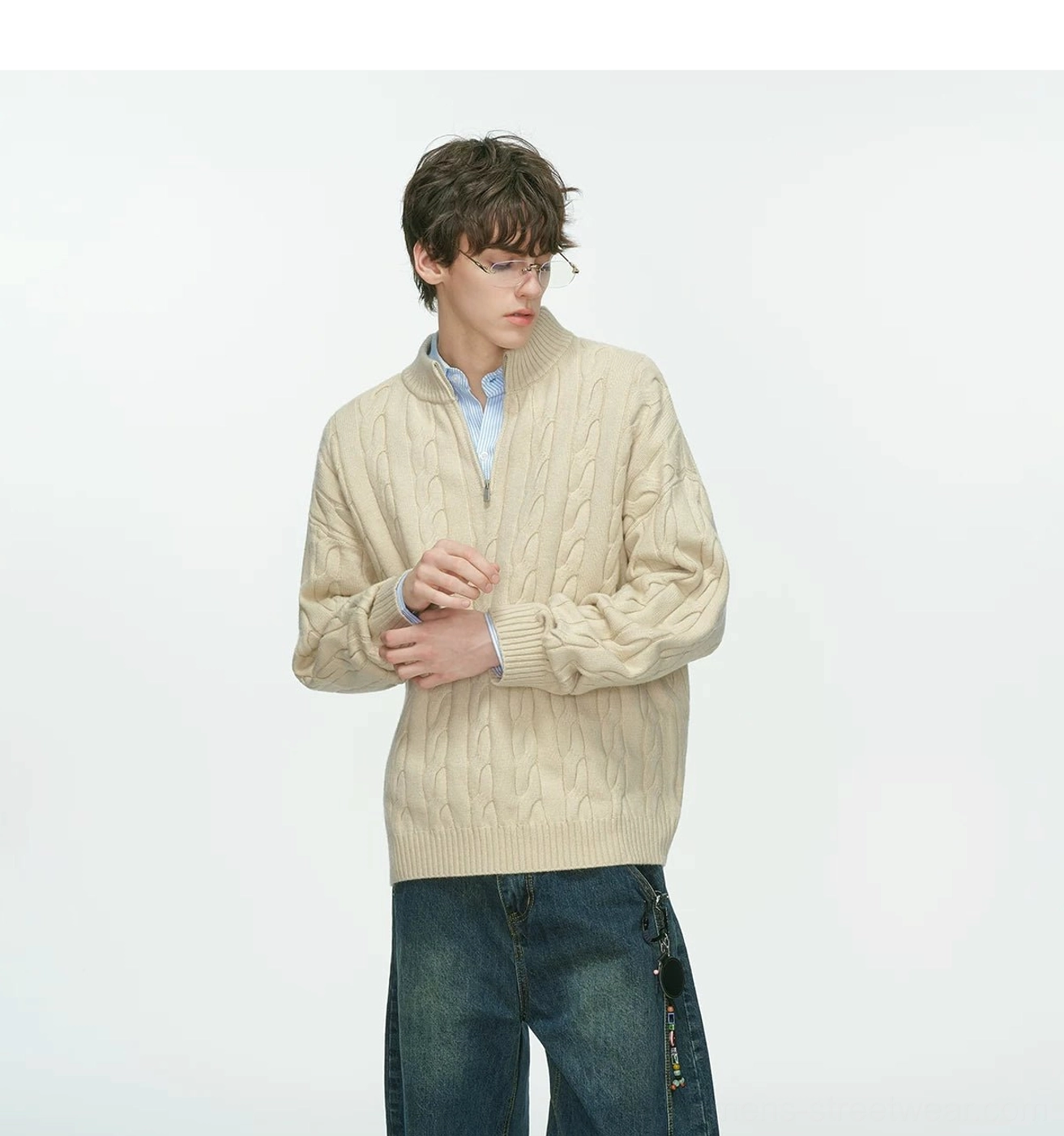 Men’s beige cable knit half-zip sweater close styling view with raised collar and collared shirt