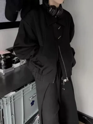 Men's black asymmetrical zip oversized bomber jacket in matte black shown in a three-quarter front view