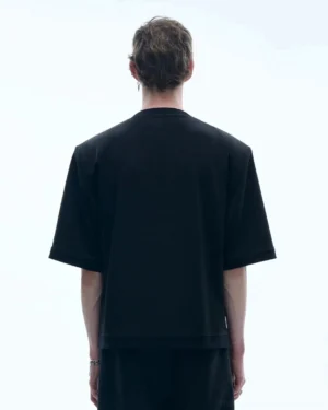 Men's black cutout collar relaxed streetwear T-shirt back view showing clean plain back and loose silhouette