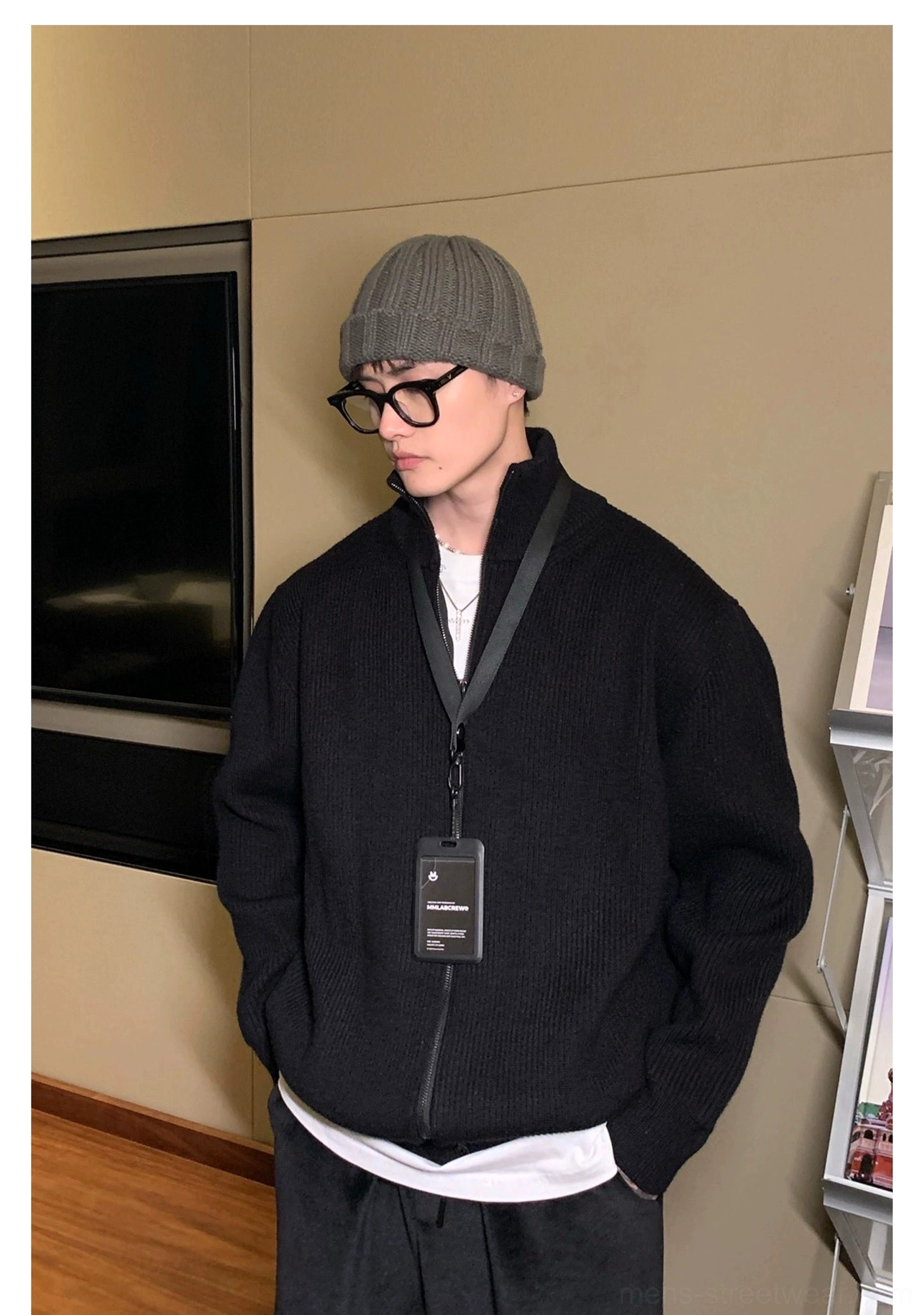 Three-quarter side view of a men's black full-zip ribbed cardigan with stand collar and casual urban streetwear styling