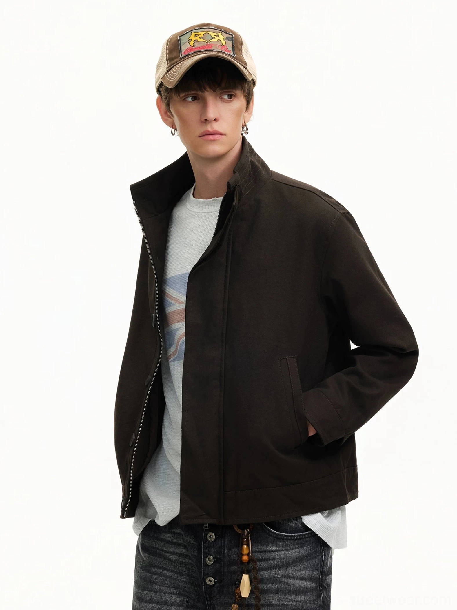 Men's black minimal stand collar Harrington streetwear jacket worn with dark denim in left three-quarter studio view