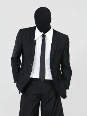Men's black minimalist tailored blazer and wide-leg trouser suit styled with white shirt and black tie front view