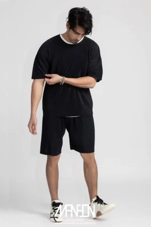 Black men's pleated casual boxy tee styled with matching pleated shorts in modern Seoul streetwear fashion