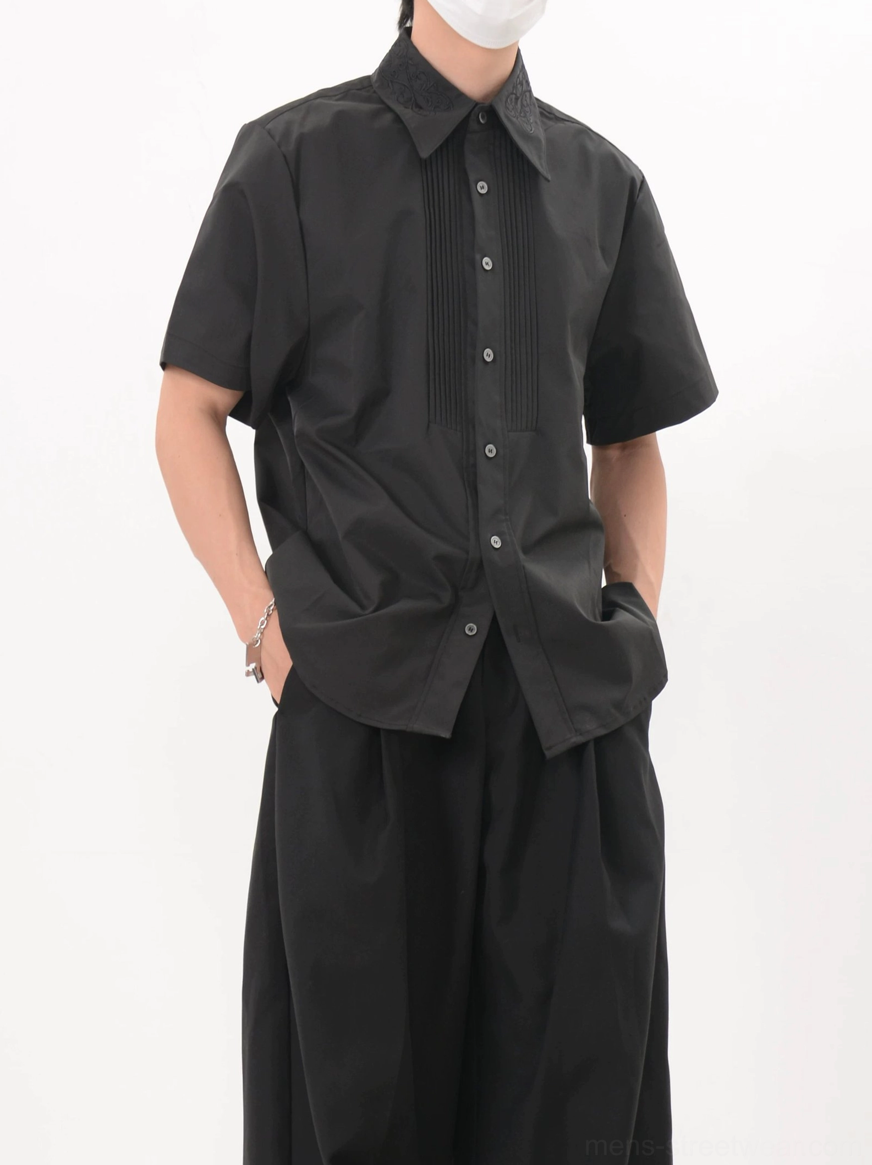 Men's black pleated formal short sleeve shirt with matte finish and full button front styling