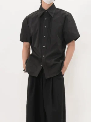 Front view of men's black short sleeve tuxedo shirt with vertical pleated bib and pointed collar