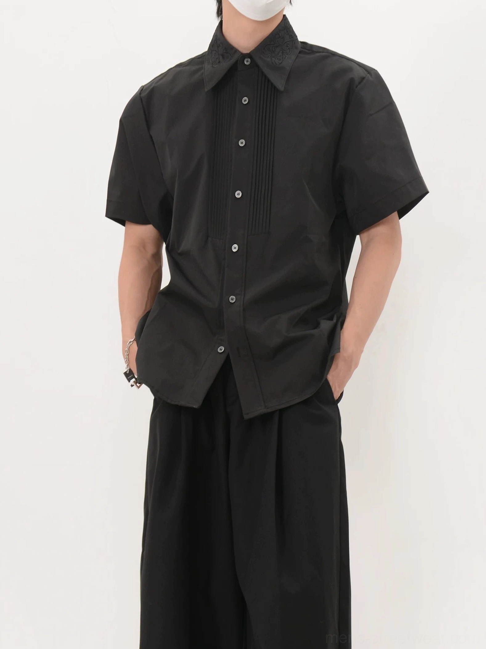 Front view of men's black short sleeve tuxedo shirt with vertical pleated bib and pointed collar