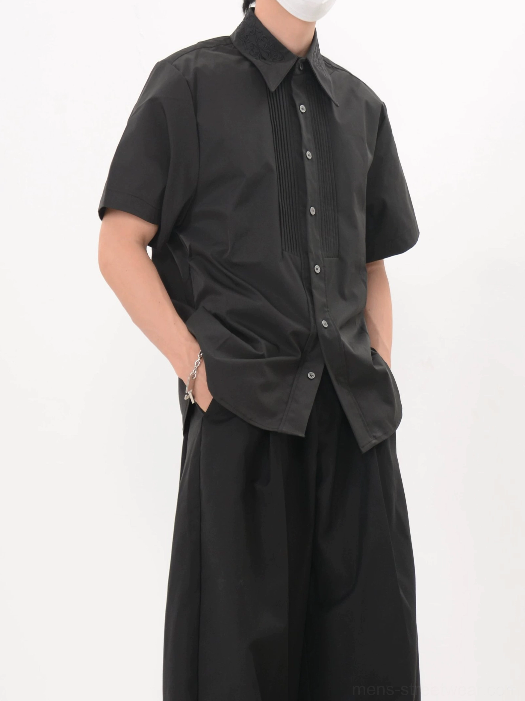 Men's black relaxed fit tuxedo pleat shirt worn with loose trousers for an avant garde Seoul streetwear outfit