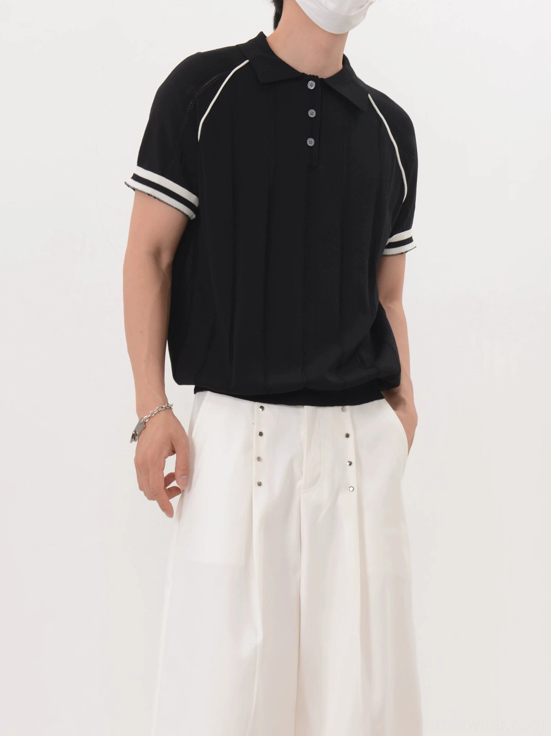 Men's black ribbed knit polo shirt with retro athletic contrast trim right three-quarter view