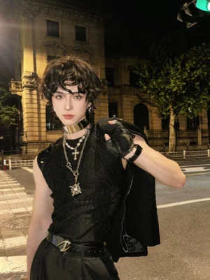 Black men's ripple textured studded sleeveless streetwear tank top worn with gothic jewelry on a night street