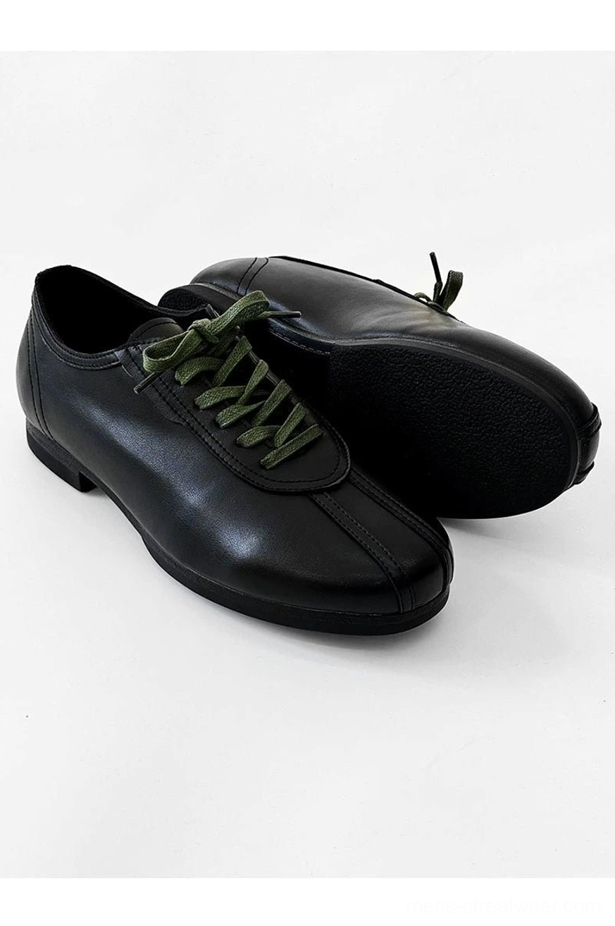 Men's black split-toe derby shoes with green flat laces, low-profile rubber sole, and versatile everyday streetwear appeal