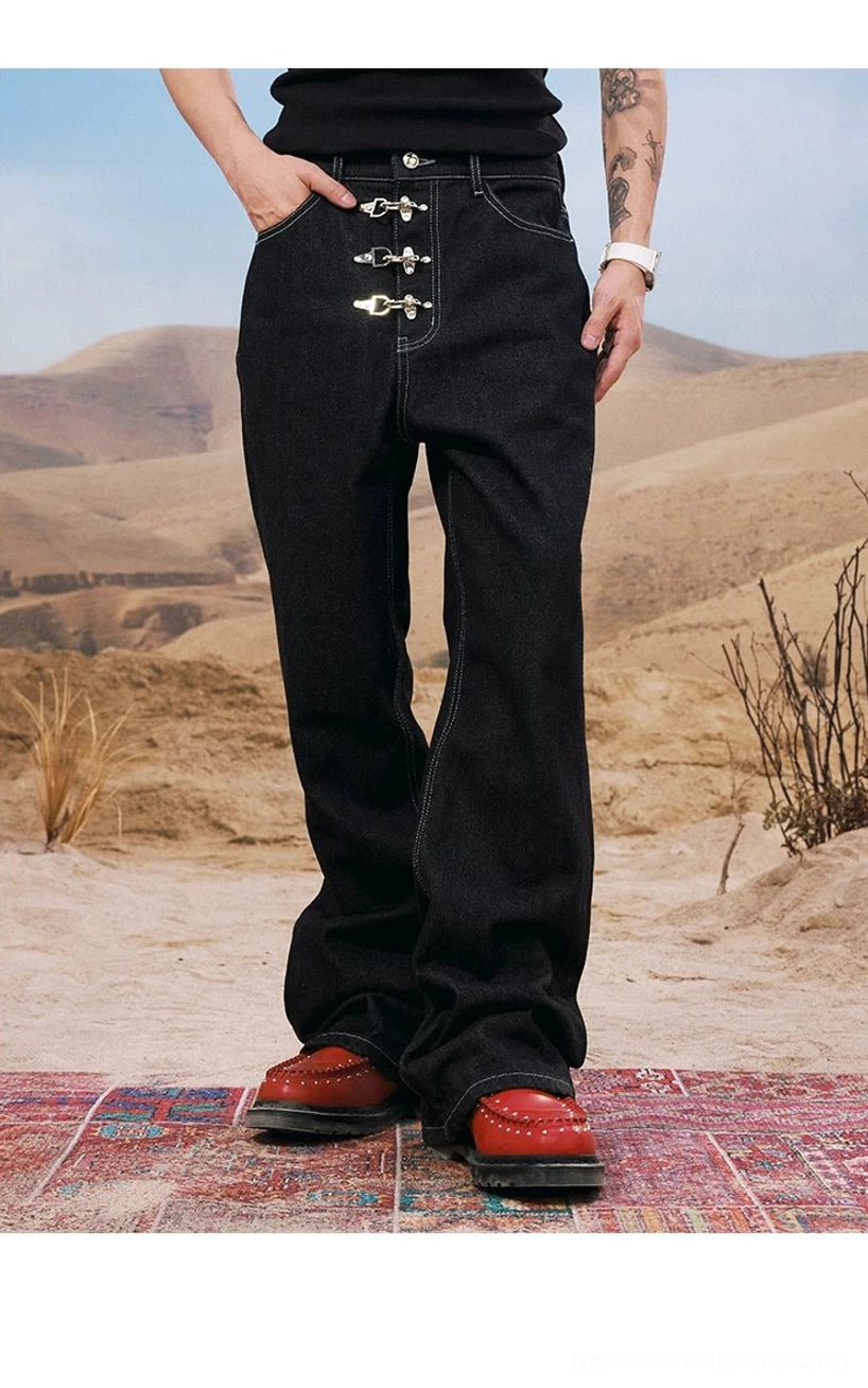 Three-quarter front view of men's black wide leg buckle jeans with silver closure and relaxed streetwear fit