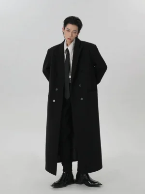 Men wearing a full-length black wool double-breasted overcoat in a three-quarter front studio view with white shirt and black tie