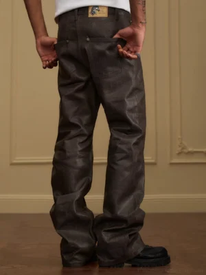 Rear view of men's brown waxed wide-leg stacked jeans with five-pocket denim construction