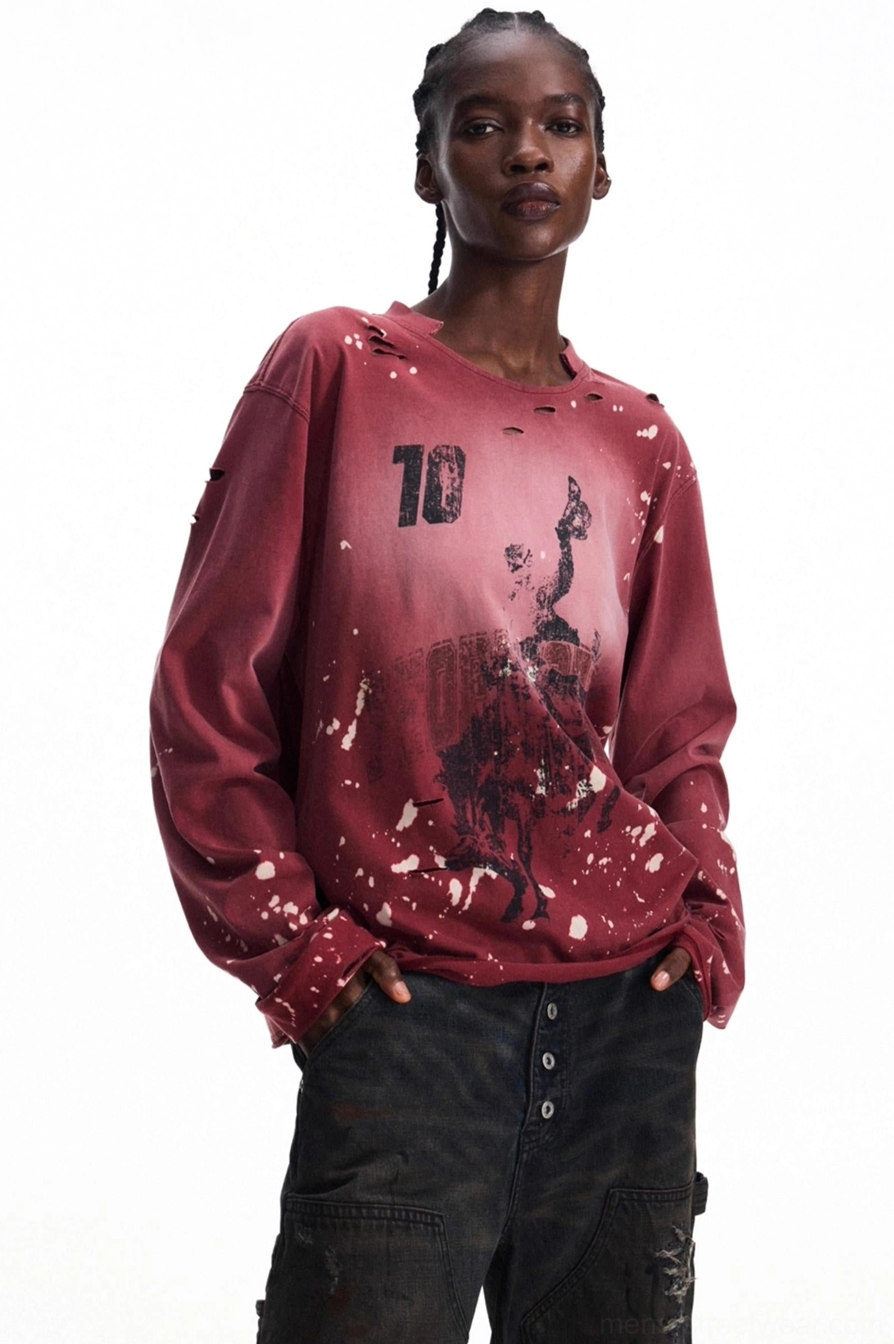 Men's burgundy vintage distressed graphic long-sleeve streetwear T-shirt in a three-quarter front view with number 10 artwork, white ink splatters, worn neckline, and dark cargo pants
