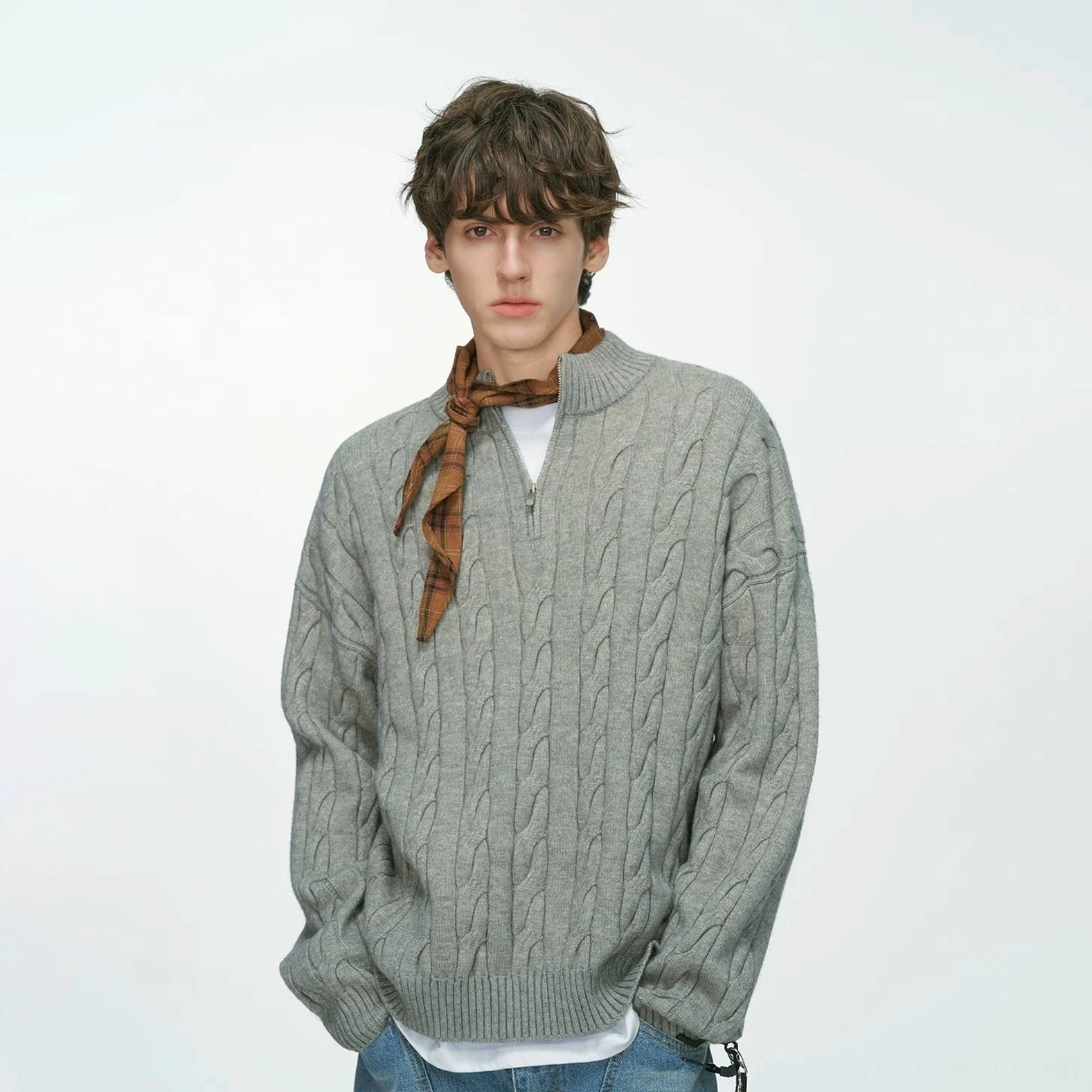 Men’s cable knit half-zip sweater showing its relaxed shape and textured knit finish