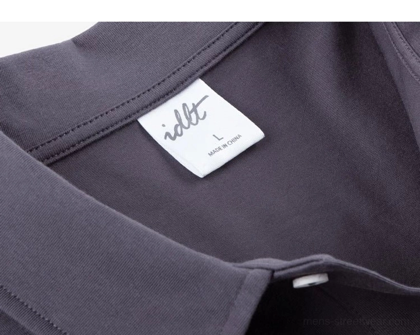 Men's casual technical knit polo shirt with left chest patch pocket, two button front, and minimalist urban streetwear styling