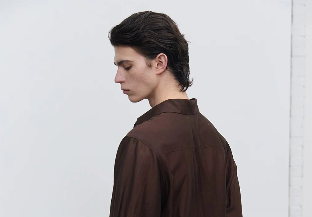 Side profile of men's dark brown fluid sheen tailored shirt showing the clean fitted silhouette, semi-sheer fabric, and subtle glossy finish