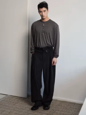 Men's dark gray relaxed fit frog button Henley long sleeve tee styled with black wide leg trousers in studio