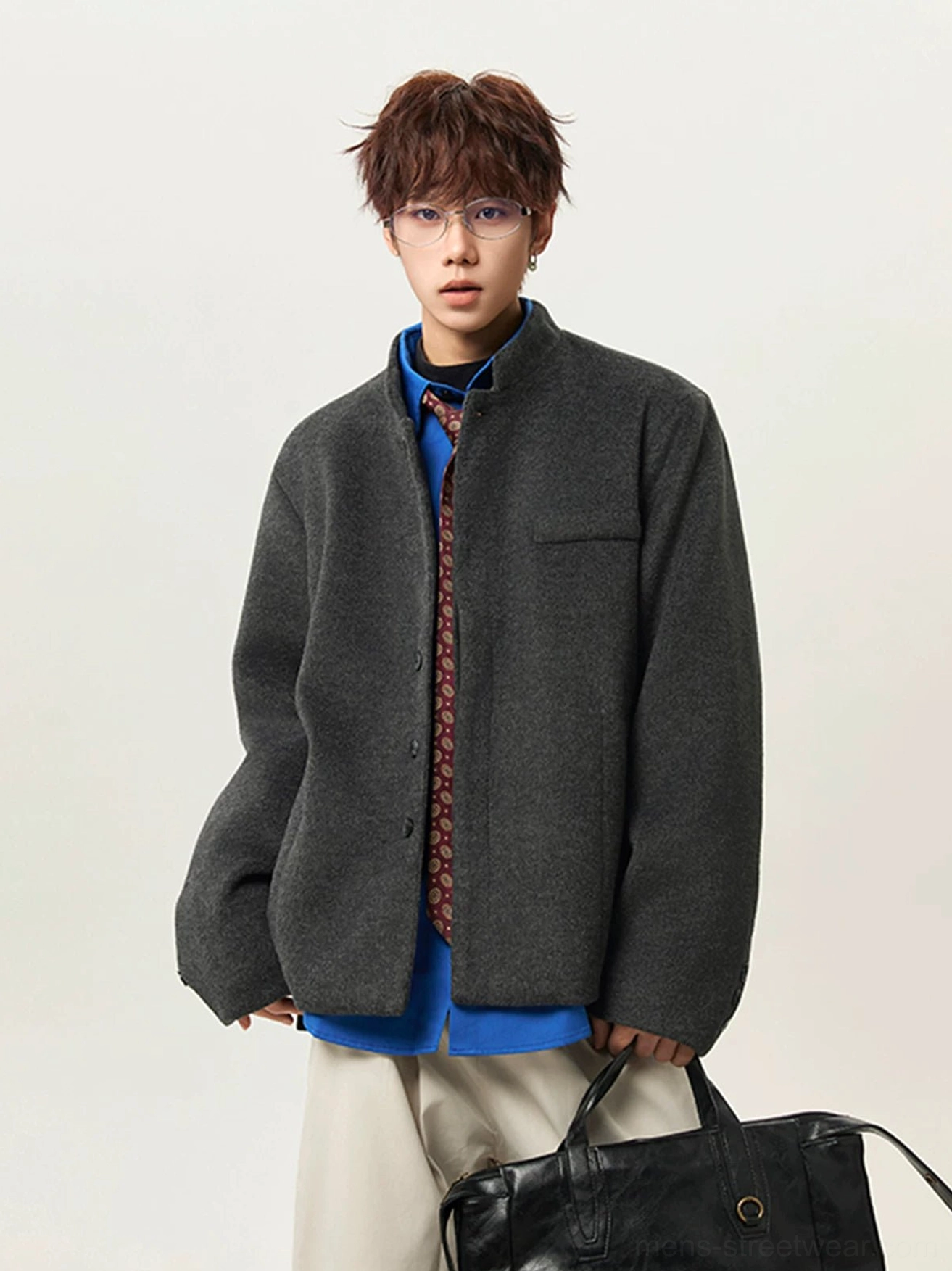 Dark gray relaxed fit stand collar wool blend jacket layered over shirt and tie with leather tote in Seoul streetwear styling