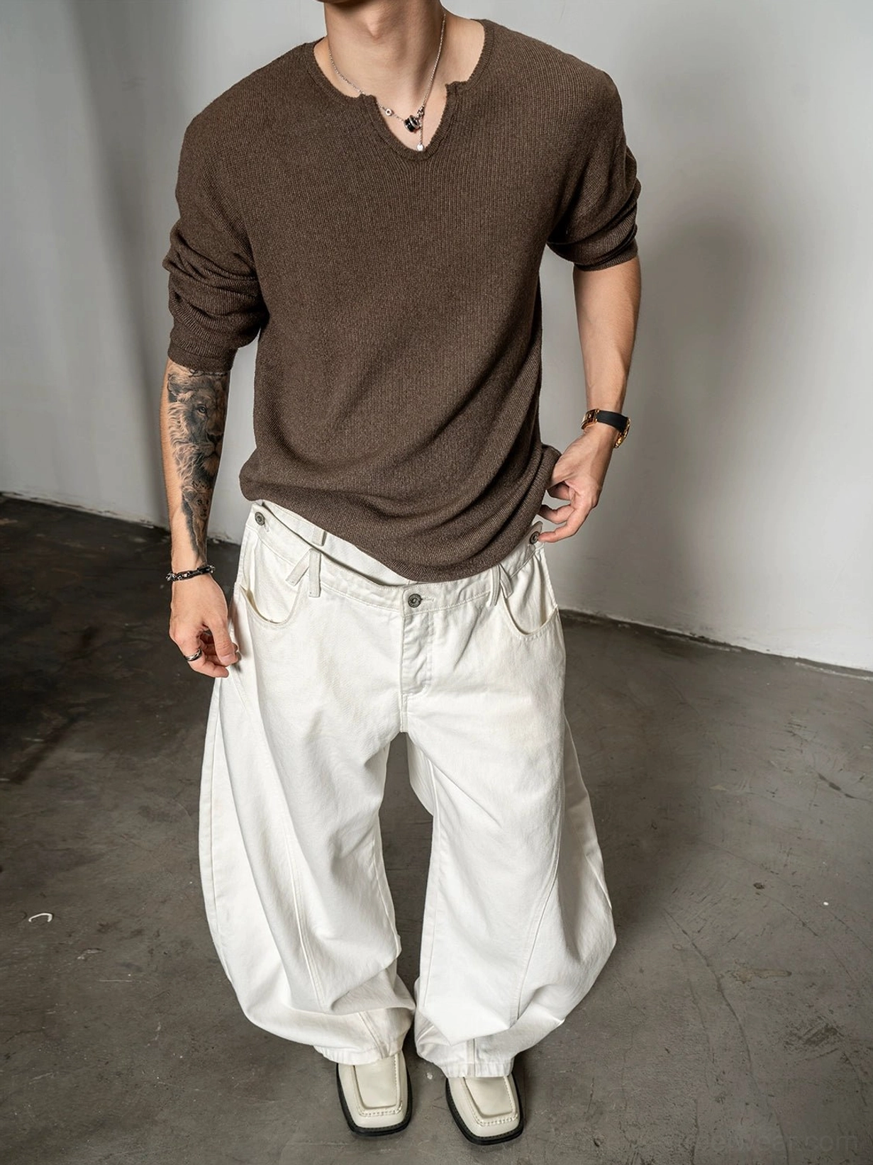 Deep brown relaxed fit men's notch neck knit sweater with fuzzy soft texture and white wide leg jeans